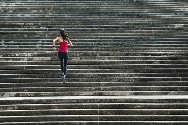 Woman running up stairs