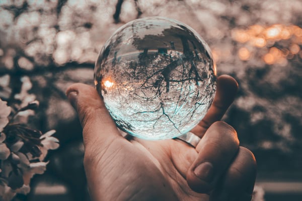 A hand holding a crystal ball