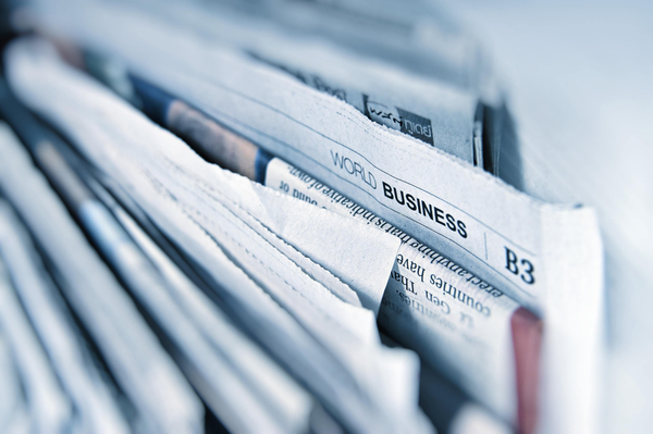 A stack of newspapers and magazines