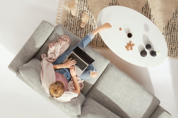 A lady sat working on her laptop in her living room