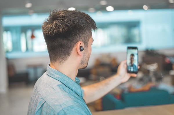 A man using a mobile phone to hold a conference call